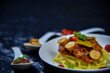 Delicious classic Italian spaghetti with tomato sauce, Parmesan cheese and mint leaves on a plate. There is a writing area.