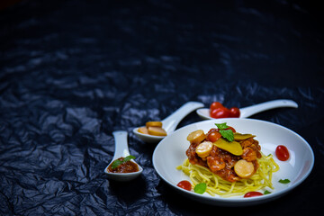 Delicious classic Italian spaghetti with tomato sauce, Parmesan cheese and mint leaves on a plate. There is a writing area.