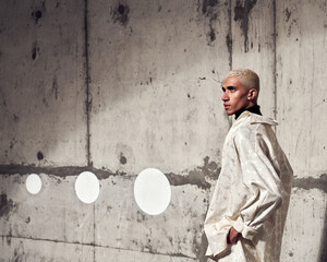 male fashion model posing in a concrete city setting