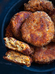 Vegetables patties or cutlets on a black plate. Top view