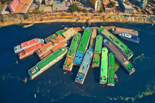 Aerial view of colourful ferry boat docket at small wharf along Buriganga river in Keraniganj, Dhaka, Bangladesh.
