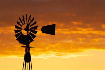 Windmill in the sunset, at the fields of Buenos Aires, Argentina