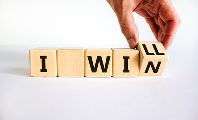 I will win symbol. Businessman turns cubes and changes words i will to i win. Beautiful white background, copy space. Business, motivational and i will win concept.