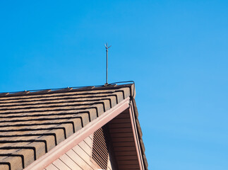 lightning rod for lightning protection is installed on the roof of the house. - 418131888