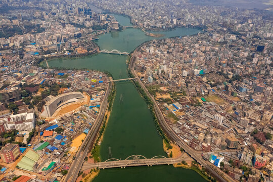 Aerial view of Hatir Jheel lake in Dhaka city center with city skyline in background, Dhaka, Bangladesh.
