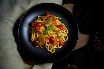 Delicious classic Italian spaghetti with tomato sauce, Parmesan cheese and mint leaves on a plate. There is a writing area.