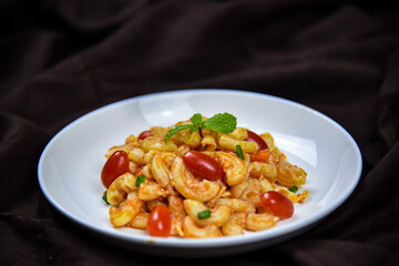 Delicious classic Italian spaghetti with tomato sauce, Parmesan cheese and mint leaves on a plate. There is a writing area.