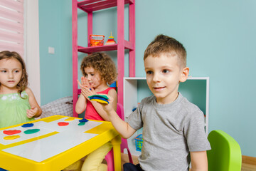 the child enjoys his work at the kindergarten