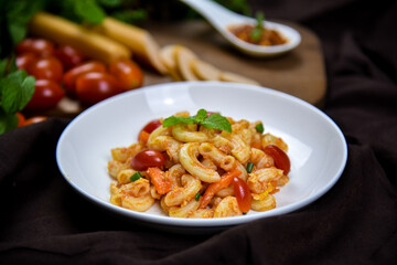 Delicious classic Italian spaghetti with tomato sauce, Parmesan cheese and mint leaves on a plate. There is a writing area.
