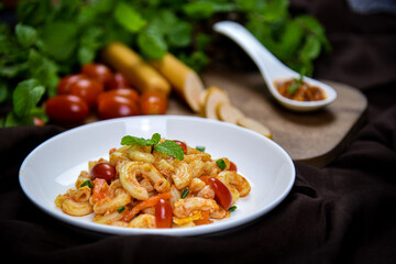 Delicious classic Italian spaghetti with tomato sauce, Parmesan cheese and mint leaves on a plate. There is a writing area.
