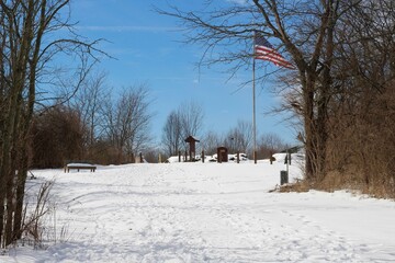 The snowy landscape at the park on a sunny winter day.
