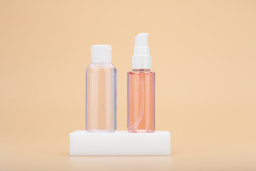 Skin hydrating or soothing lotion and cleansing foam or gel on white podium against beige background. Beauty products for skin treatment at home
