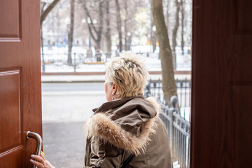 woman leaving a house