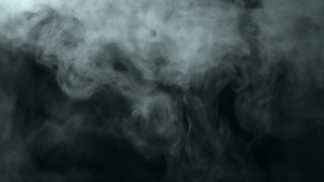 White steam. Foggy texture. Steam from humidifier against light on black background