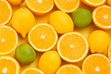 Citrus fruits isolated on yellow background.