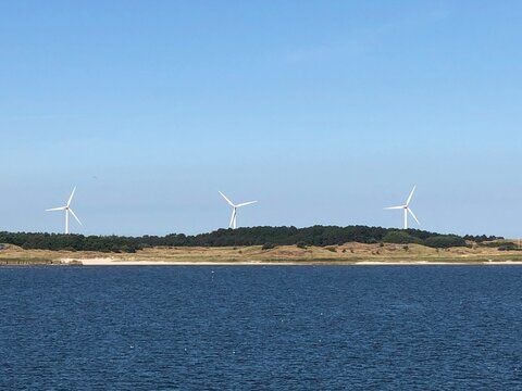 Three wind turbines along the coastline, Fanoe, Jutland, Denmark