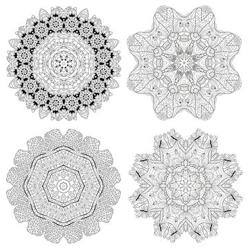 Hand drawn zentangle set of 4 mandalas for coloring page.