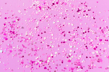 Naklejka premium Abstract background of pink heart-shaped sparkles.