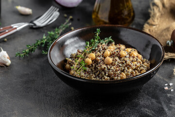 Close-up view of bowl of quinoa salad with chickpea. Buddha bowl with quinoa, chickpeas and thyme. Super food, Food recipe background. top view
