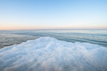 Winter Baltic Sea. The beach in the snow in the foreground. Sea horizontal background.