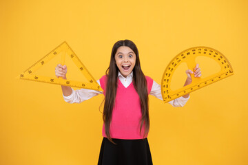 surprised kid girl use protractor and triangle to learn mathematics, measurement