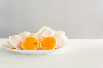 Traditional portuguese sweets called Ovos Moles de Aveiro on white wooden table with copy space