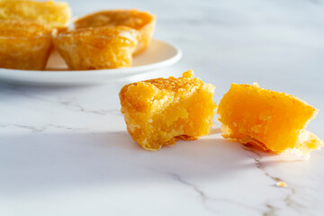 Portuguese sweet bean tart called Pastel de Feijao on marble background