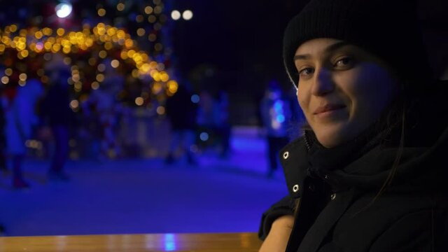 Young woman near the ice rink during the Christmas holidays