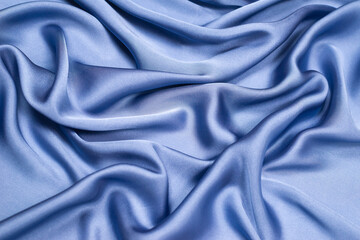 Blue silk or satin luxury fabric texture. Top view.