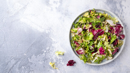 Fresh mix greens on a plate. Fresh salad plate. Top view, text space