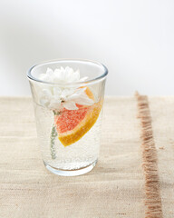 water on the table with citrus fruits