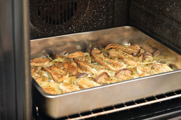 Tray with seasoned sliced king trumpet mushrooms (pleurotus eryngii), potatoes and onions in the oven. Mediterranean diet.