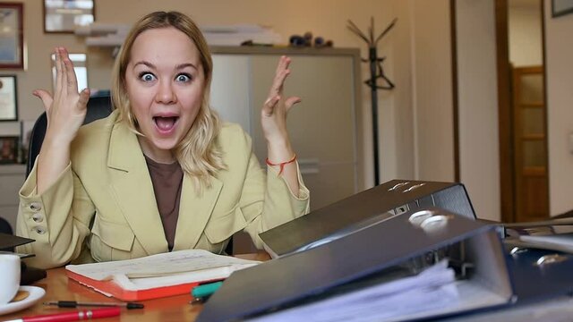 A lot of Paperwork and sad woman. Bored sad worker tired unmotivated and disinterested in dull work with laptop paperwork. Office clerk working, adding folders more work.
