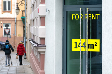 For rent sign on the door of a shop, bar or restaurant in the city center closed for bankruptcy due...