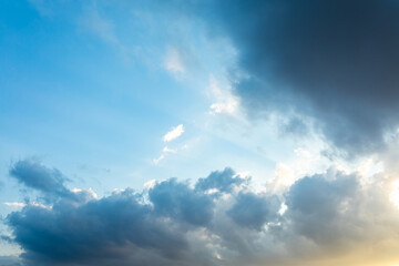 Naklejka na ściany i meble Dark blue clouds on a blue sky at sunset. Natural background