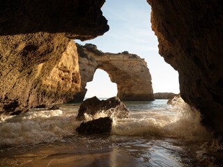 Panorama view of natural limestone arch bridge Arco de Albandeira beach atlantic ocean cove bay in...