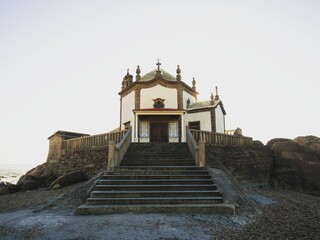 Panorama view of Senhor da Pedra chapel church religious pilgrimage building on Miramar sand beach...