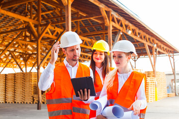 Group of young architects and engineers in helmets