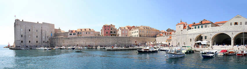 Fototapeta na wymiar Panoramic view of Dubrovnik, Croatia. Turquoise waters of Adriatic Sea. Entrance to Dubrovnik inner harbour