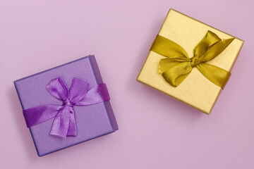 boxes for presentations of different colors on a pink background. Festive backdrop for holidays: Birthday, Valentines day, Christmas, New Year.