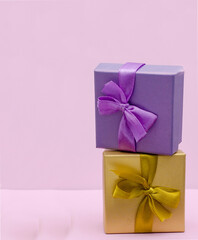 boxes for presentations of different colors on a pink background. Festive backdrop for holidays: Birthday, Valentines day, Christmas, New Year.