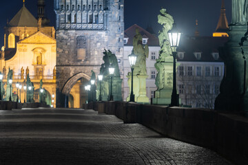 empty charles bridge at night and bridge towers in the center of prague