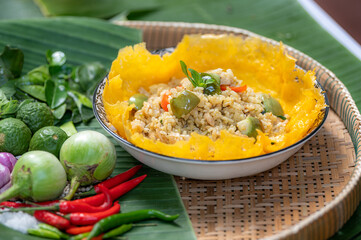 Bangkok - Thailand  17 January 2021 : Thai food - green curry fried rice on banana leaf background.