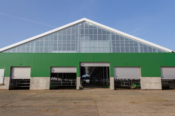Naklejka premium Building under construction with sandwich panel of insulation on the wall. Construction of a new industrial building.