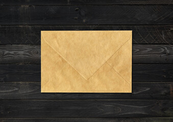 Brown paper enveloppe mockup template on black wood background