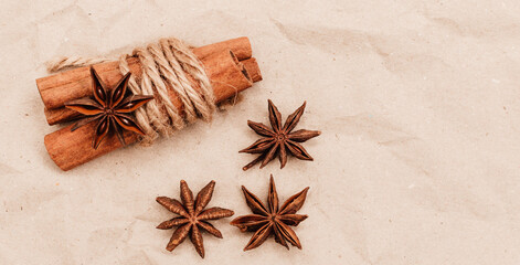Warming spices - cinnamon and star anise with wooden spoons, chopsticks on vintage wood table.