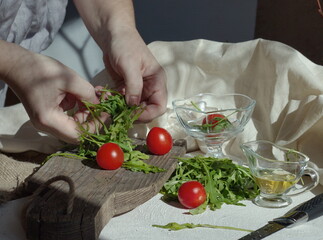 The process of cooking vegetable salad, man's hands are preparing the dish
