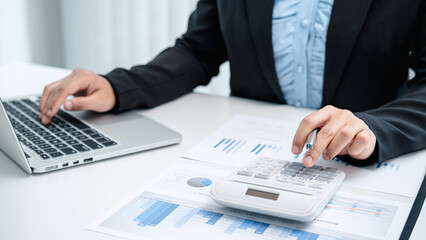 Business woman use calculator to calculate investment figures