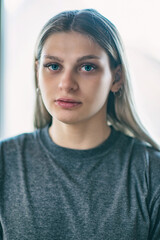 Close-up portrait of a simple blonde green-eyed girl.