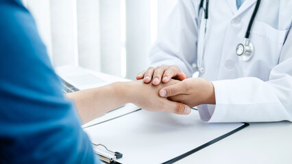 Obraz na płótnie Canvas Doctor holding touching hand after reading bad result at clinic